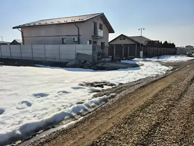 Teren de vanzare Balotești Ilfov iarna drum neasfaltat
